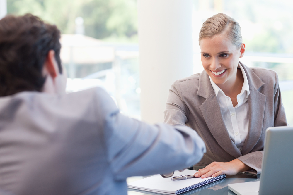 Manager interviewing a male applicant in her office